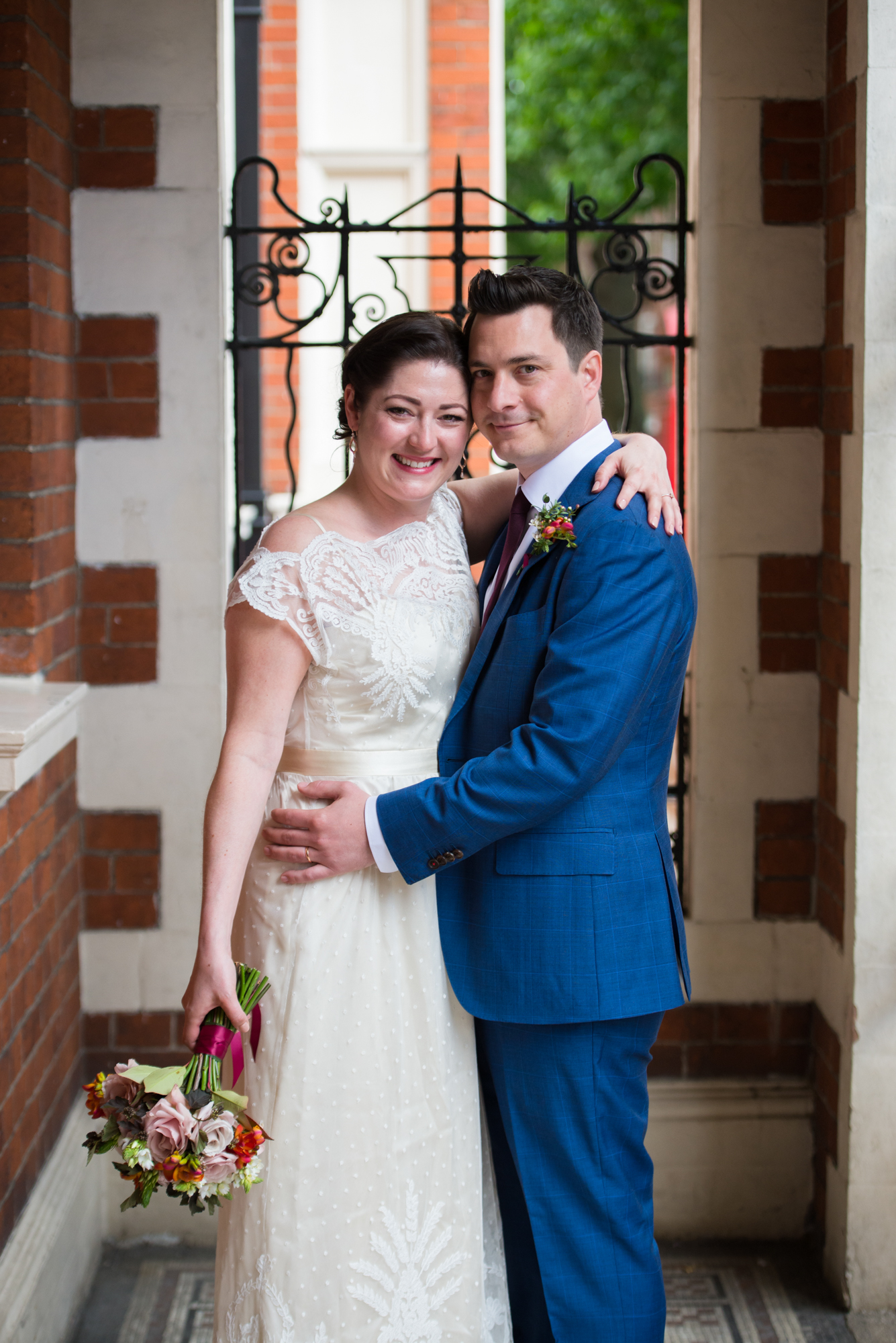 small and intimate wedding photography at Mayfair Library in London bride and groom in the entrance